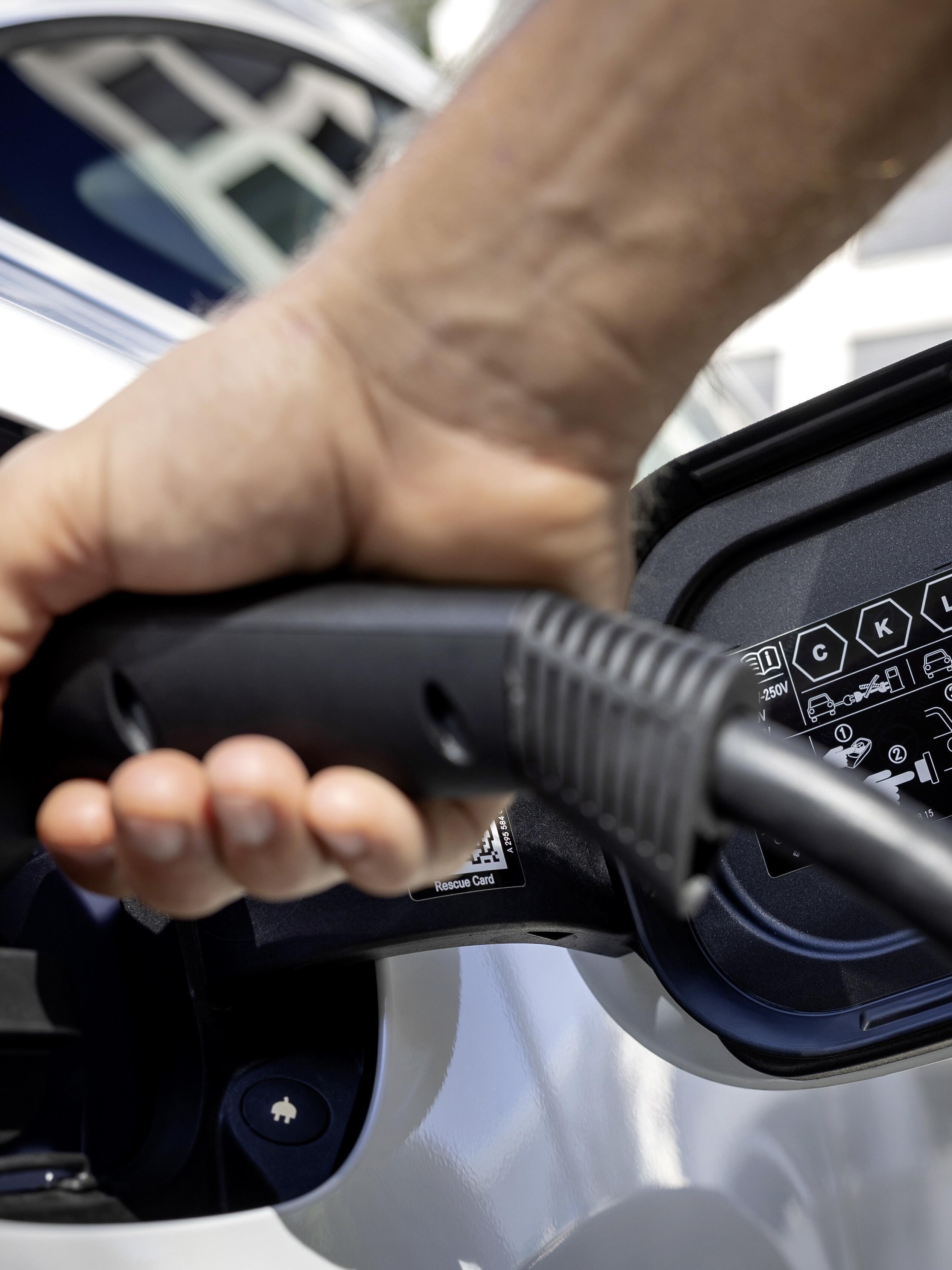 Image of person plugging in EV charger