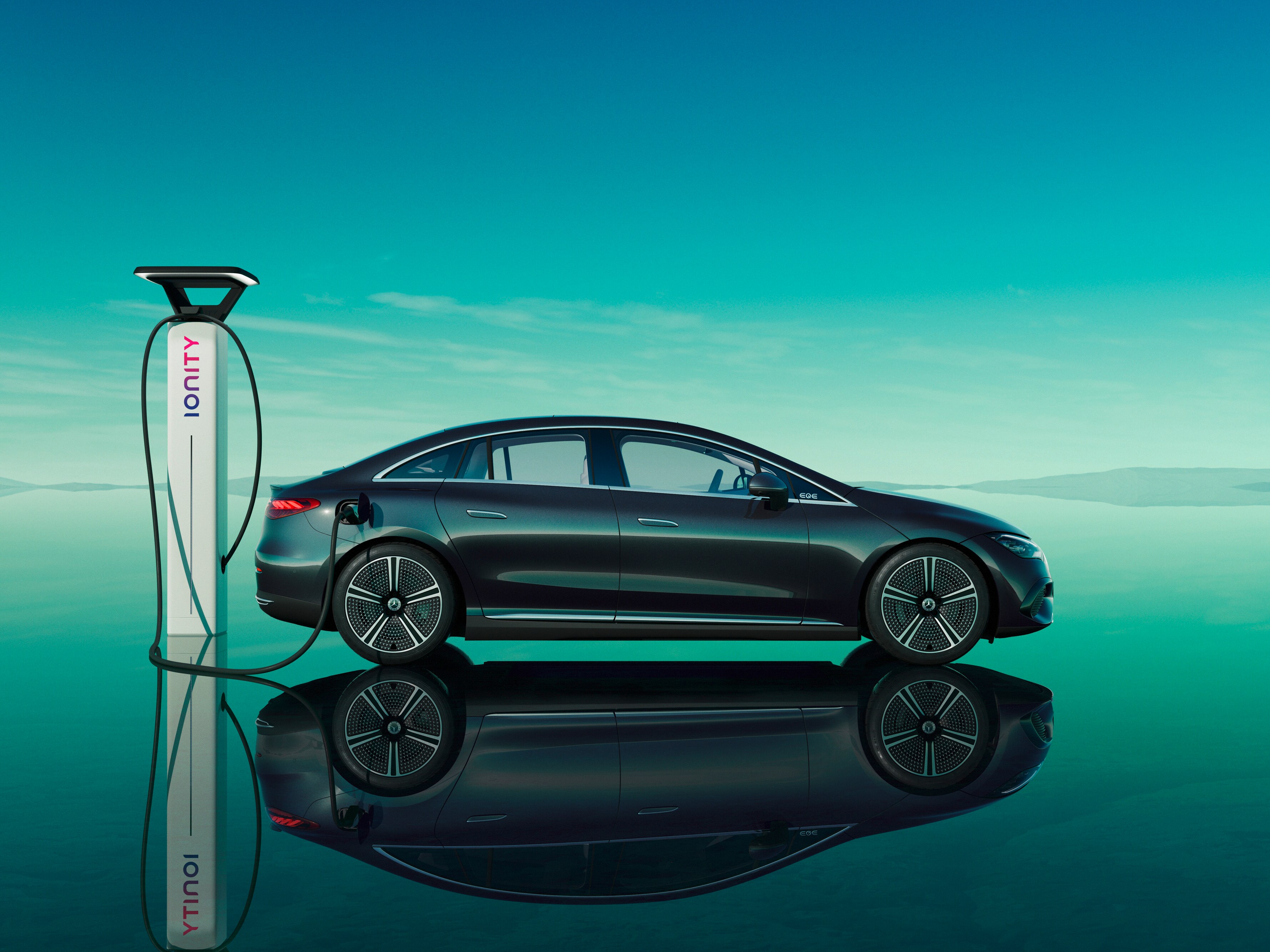 Black Mercedes-Benz Ionity charging against teal reflective backdrop