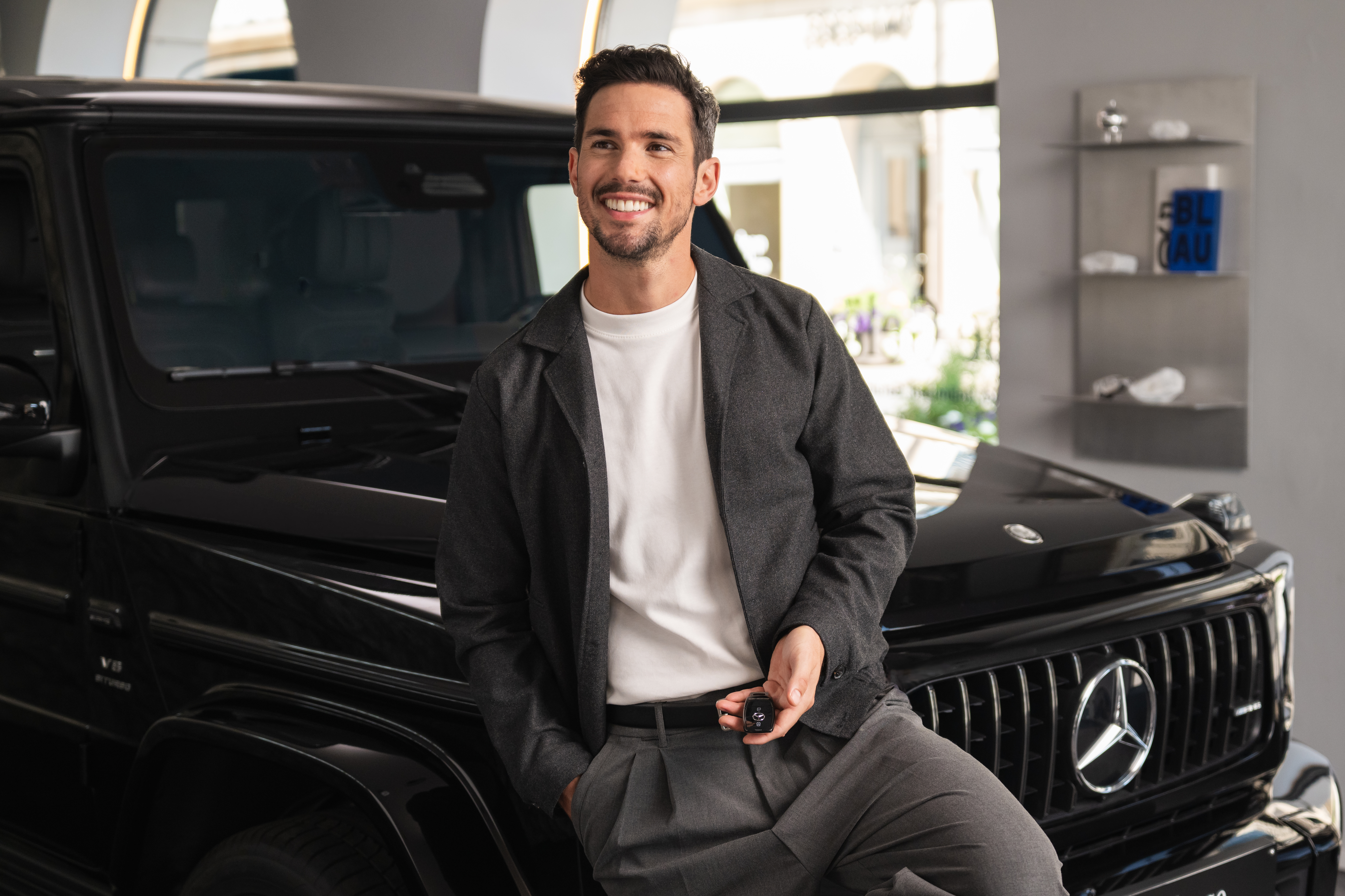 Agility (PCP) A person smiling in front of a Mercedes-Benz.