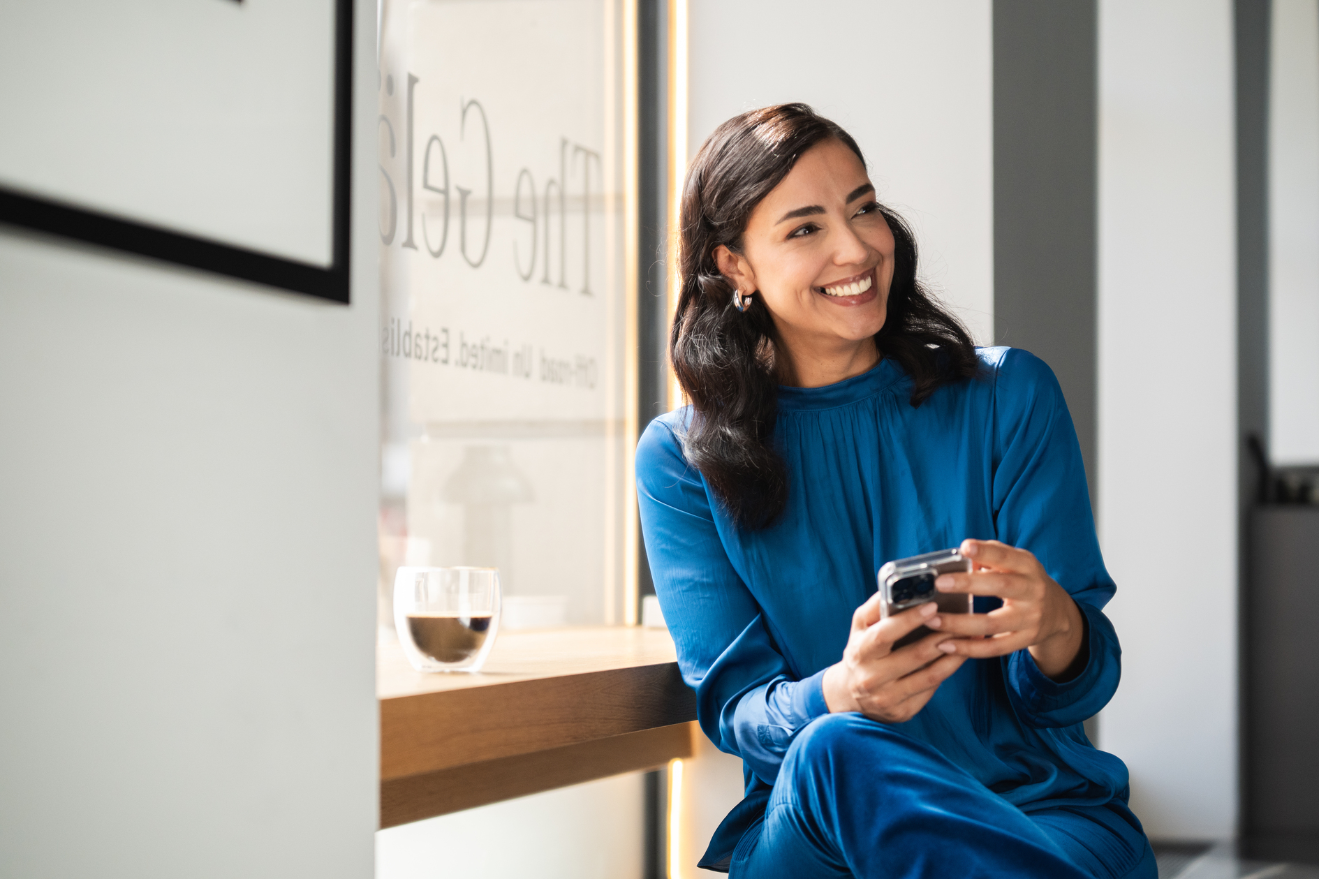 Operating Lease A person smiling and looking at her phone.