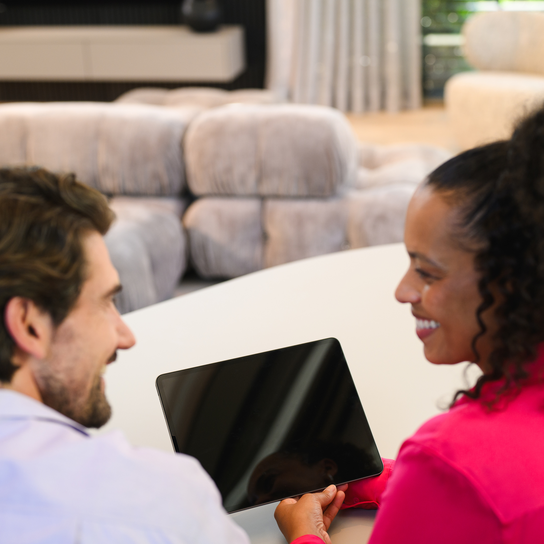 Couple at home smiling over a laptop Couple at home smiling over a laptop.