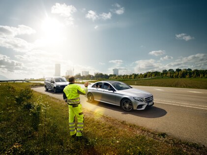 mechanic attending car with flat tyre - Mercedes-Benz minor mishap