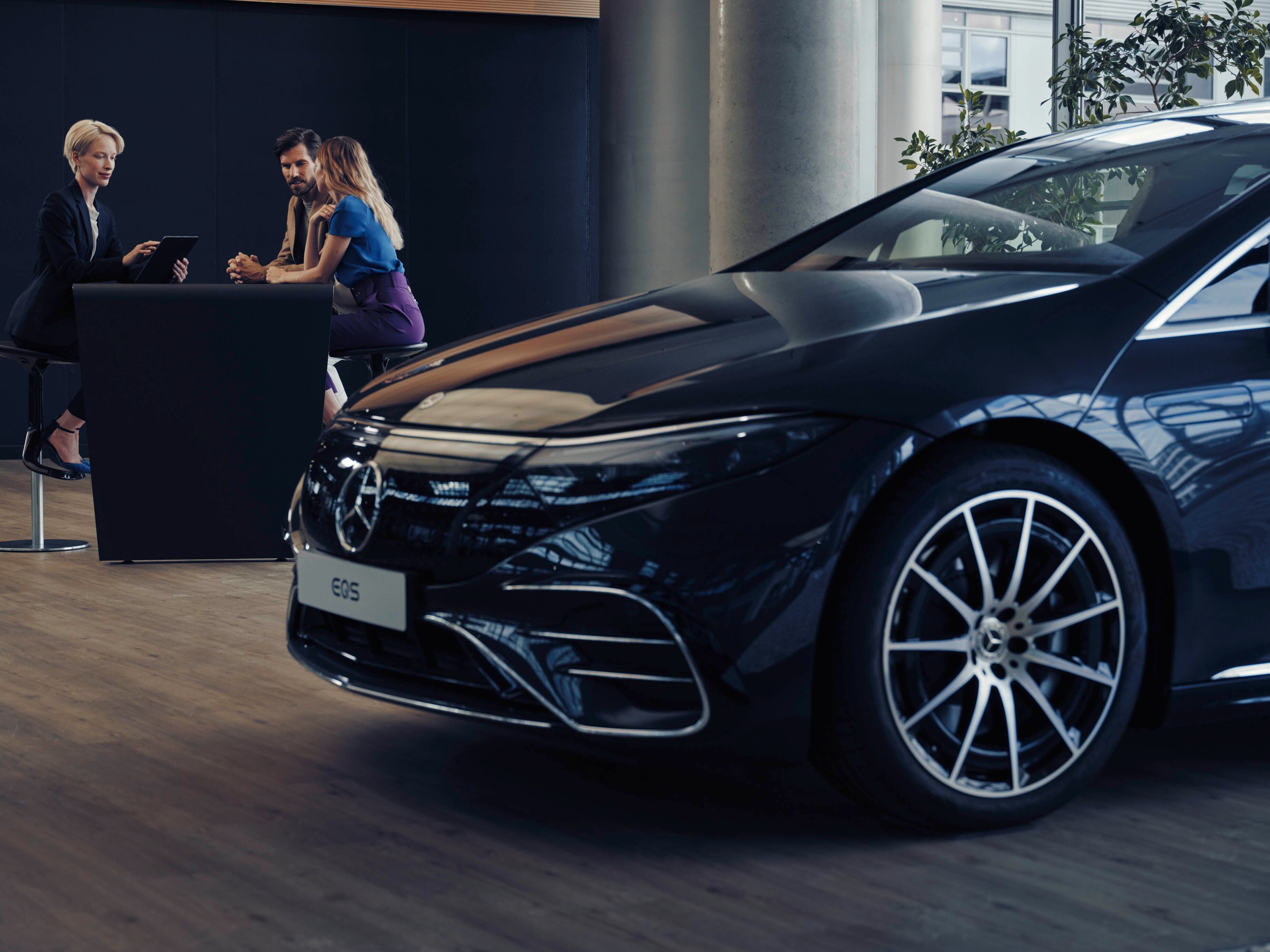 Man and woman talking with Mercedes-Benz dealer