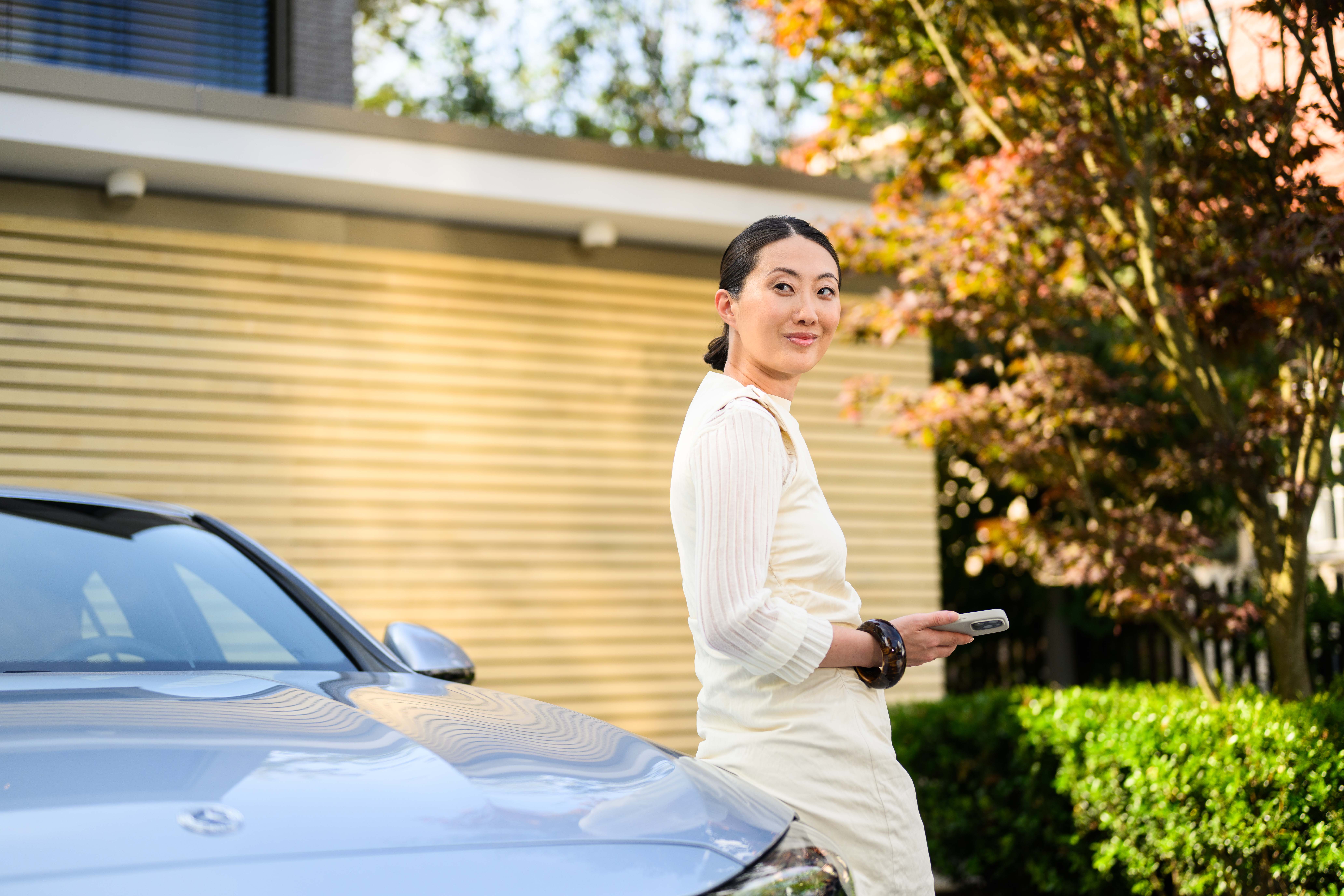 Contract Hire Title A person leaning against a Mercedes-Benz outside their house.