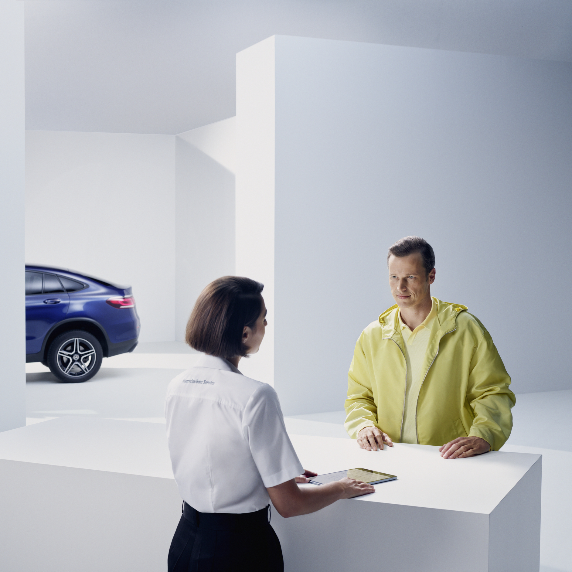 A pleasant journey with the Mercedes-Benz warranty for new vehicles. | Mercedes-Benz A woman, standing in front of her Mercedes and looking in a good mood.