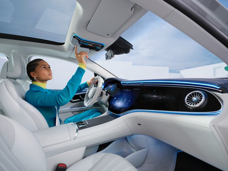 A Mercedes-Benz driver selects the Mercedes me button in the overhead control panel.