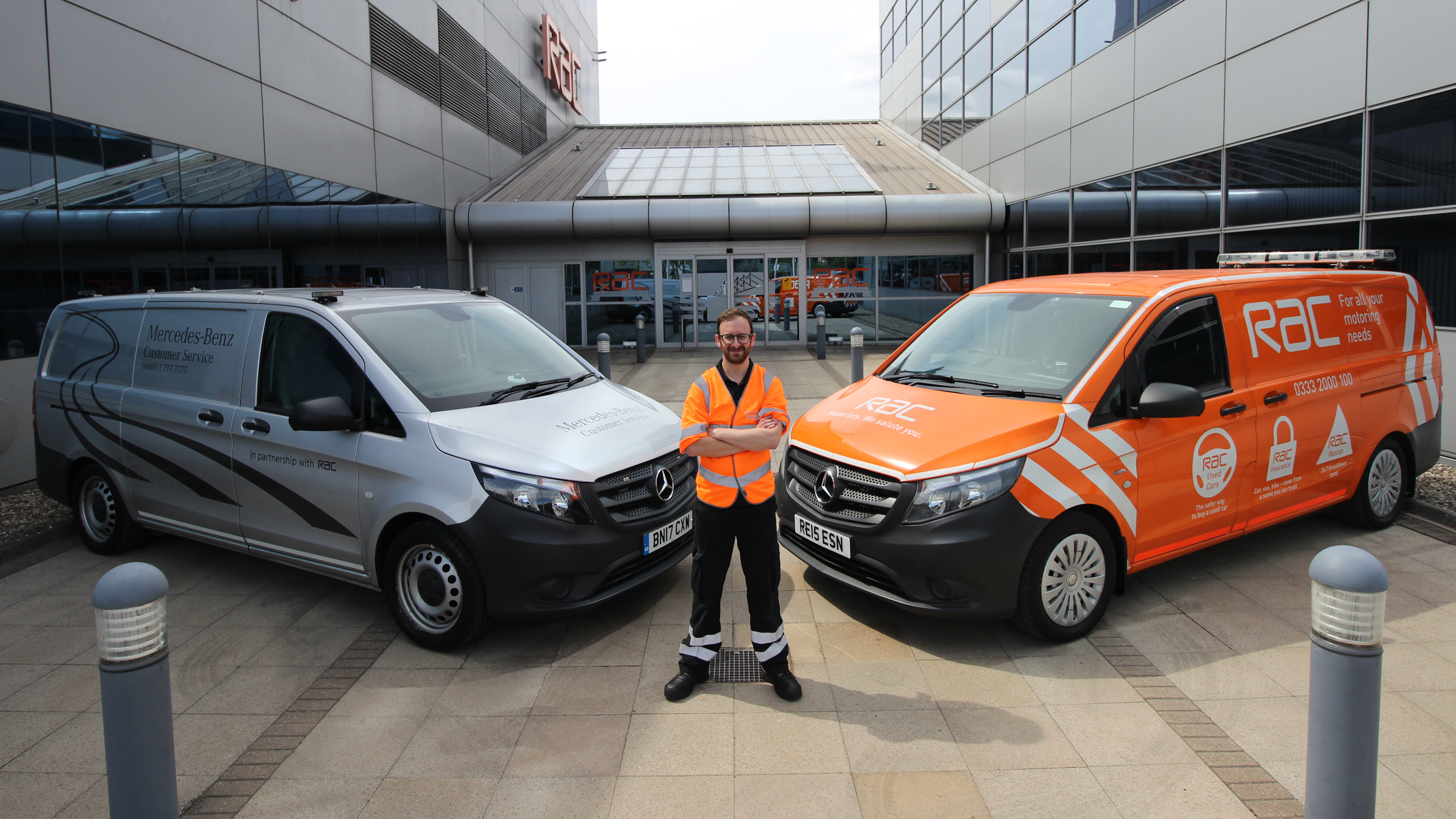 RAC Roadside assistance RAC Roadside assistance staff member standing in front of two RAC vans