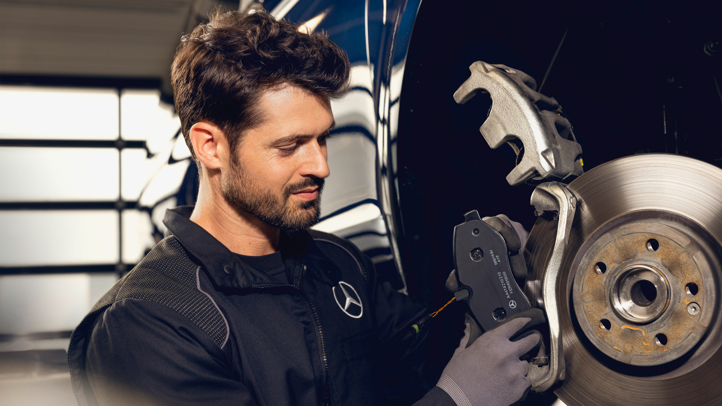 Mercedes-Benz GenuineParts A Mercedes-Benz technician checks the brakes of a vehicle on the test bench.