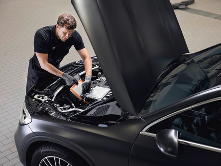 A Mercedes-Benz technician inspects an engine air filter.