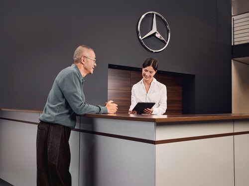 A Mercedes-Benz technician inspects an engine air filter.