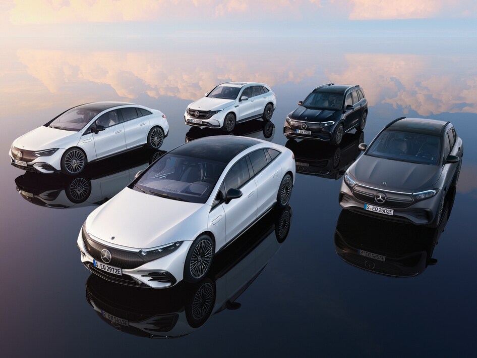 Five Mercedes-Benz cars on reflective surface with cloud background