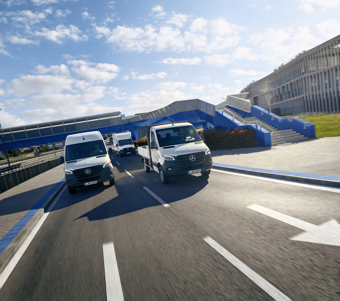A Group of eSprinter Vans on the Road | Mercedes-Benz Vans An eSprinter Panel Van, eSprinter Chassis Cab and eSprinter Luton Box on a road.
