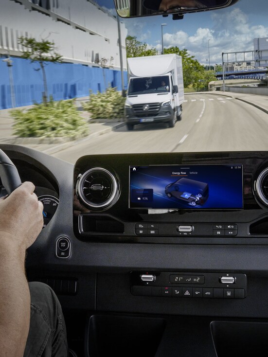 eSprinter van dashboard with MBUX screen and oncoming van visible through the windshield.