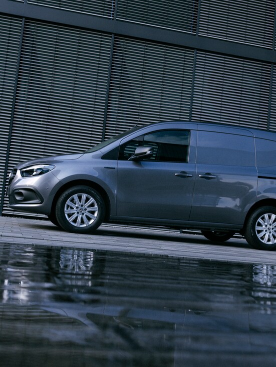 A grey Mercedes-Benz Citan panel van in front of a building.