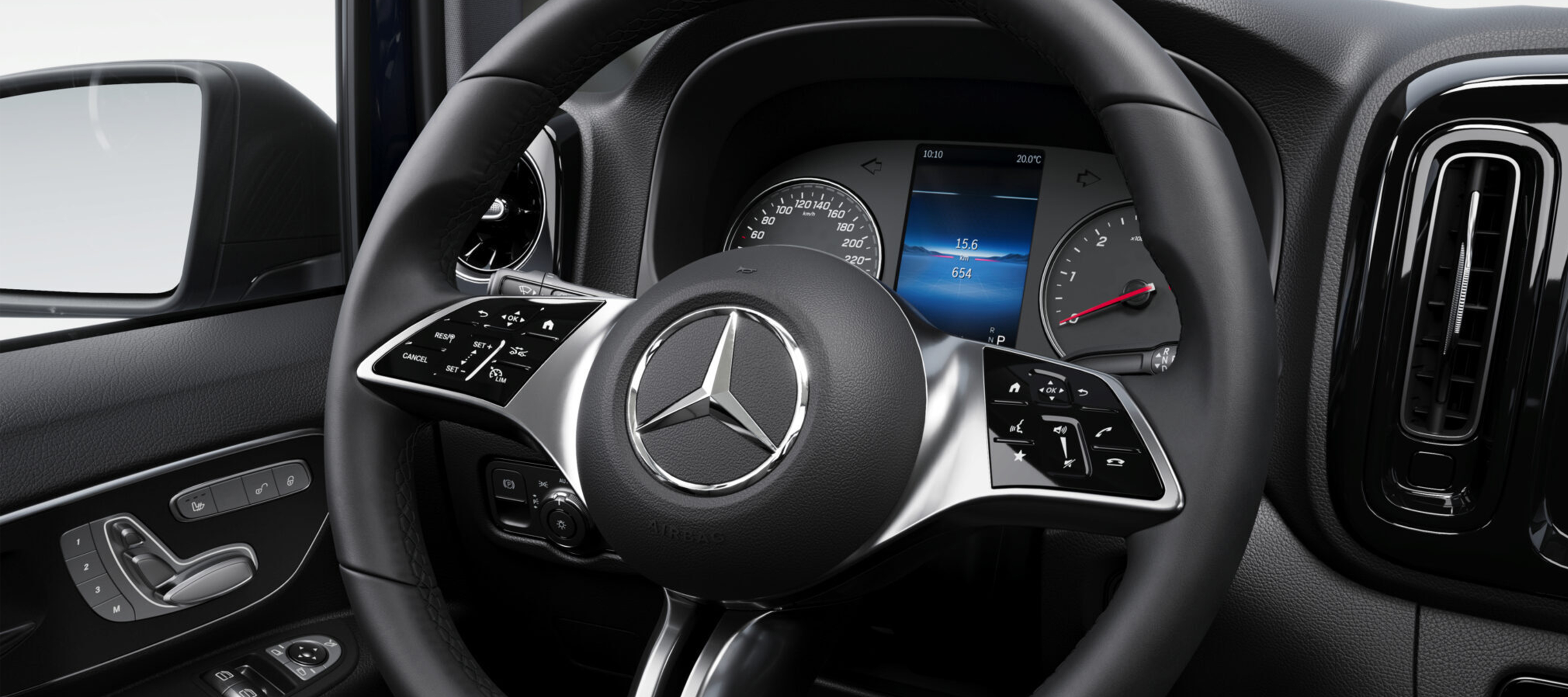 Steering wheel and dashboard close-up | Mercedes-Benz Vans Close-up of a Mercedes-Benz steering wheel and dashboard inside vehicle cabin.