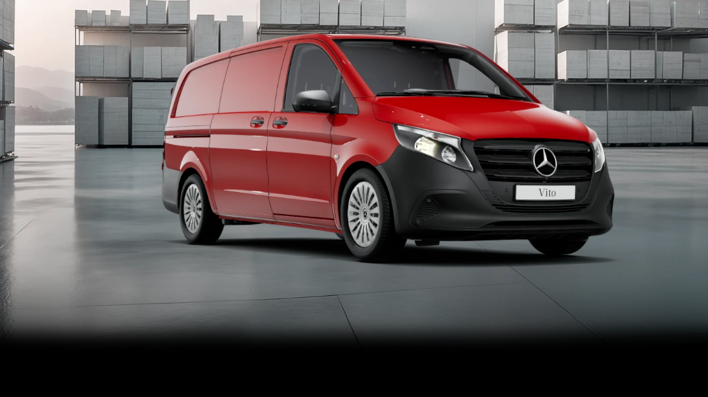 White Mercedes-Benz Vito Panel Van parked by modern concrete structure.