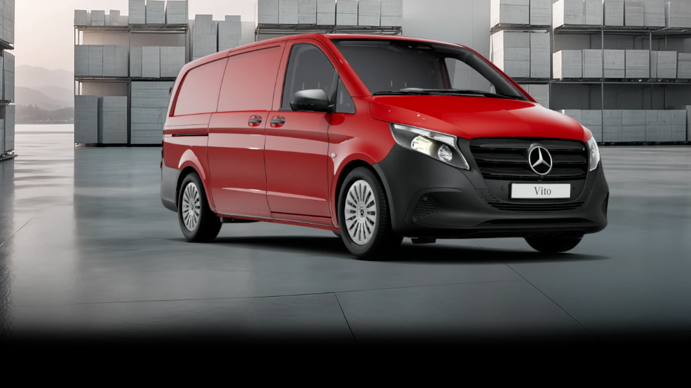 White Mercedes-Benz Vito Panel Van parked by modern concrete structure.