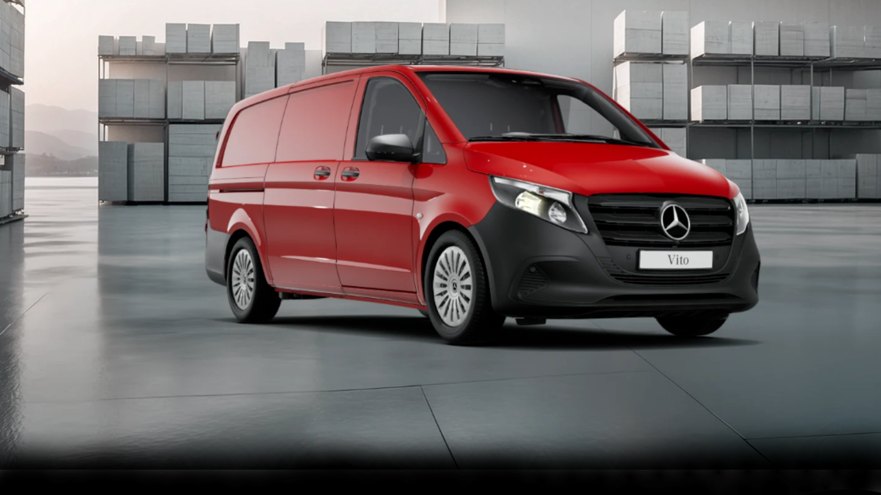 White Mercedes-Benz Vito Panel Van parked by modern concrete structure.