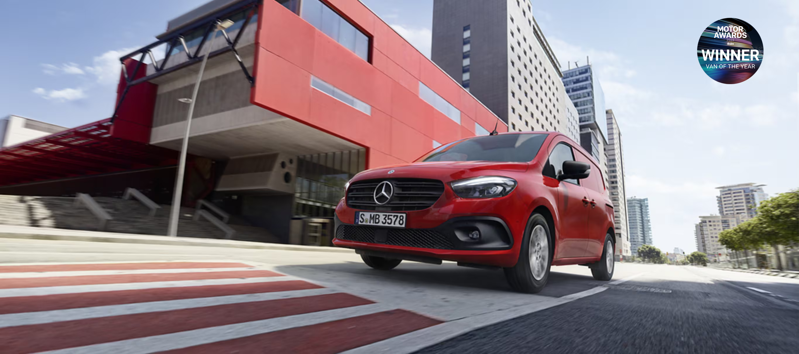 Citan | Mercedes-Benz Vans The Mercedes-Benz eCitan in its tourer and panel van versions standing in front of a site of industrial aspect.