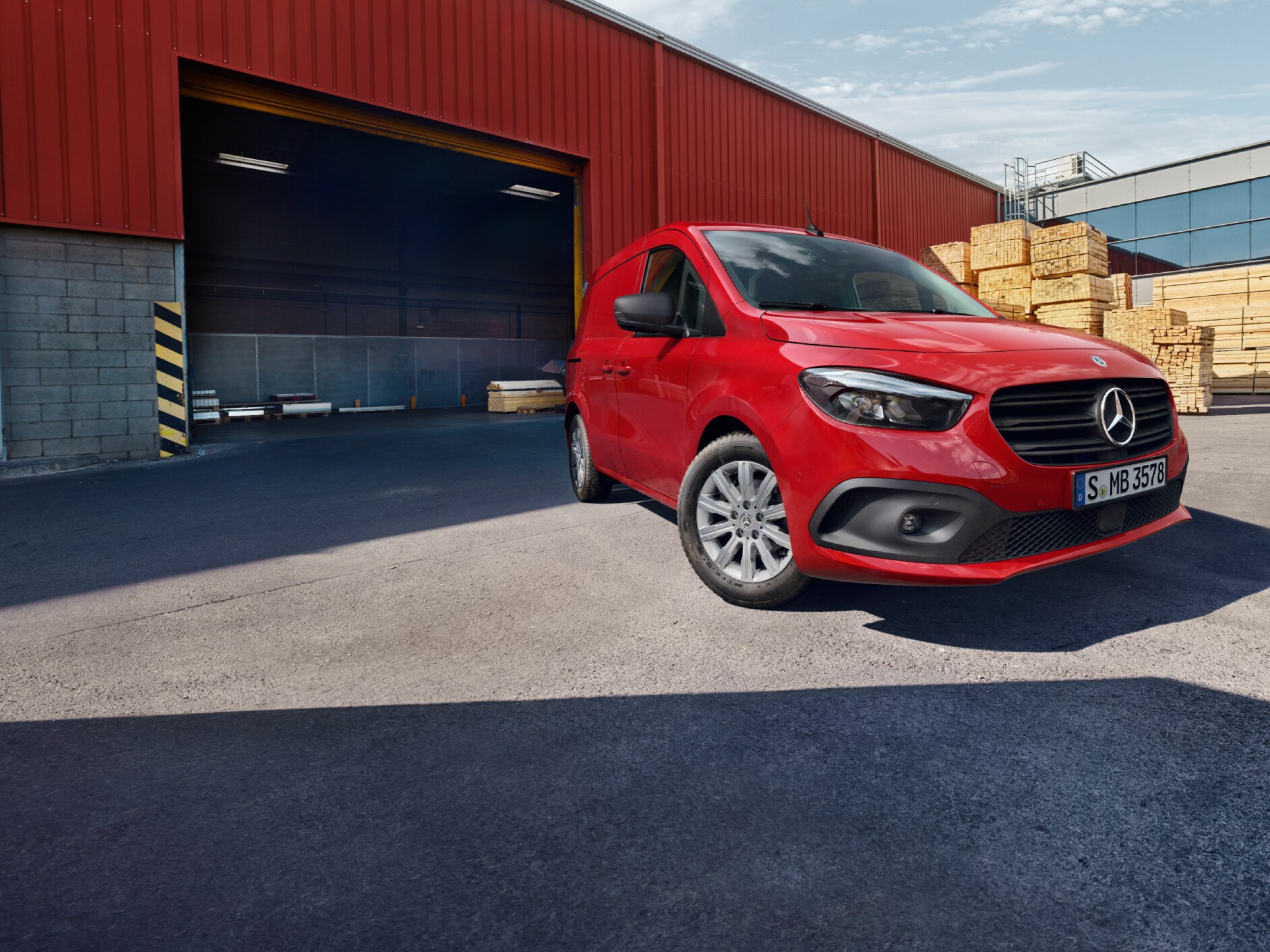 A Mercedes-Benz eCitan Panel Van standing on a logistics site.