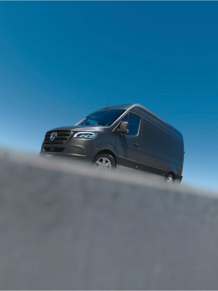 Side-view of a dark grey Mercedes-Benz eSprinter Panel Van on tarmac.