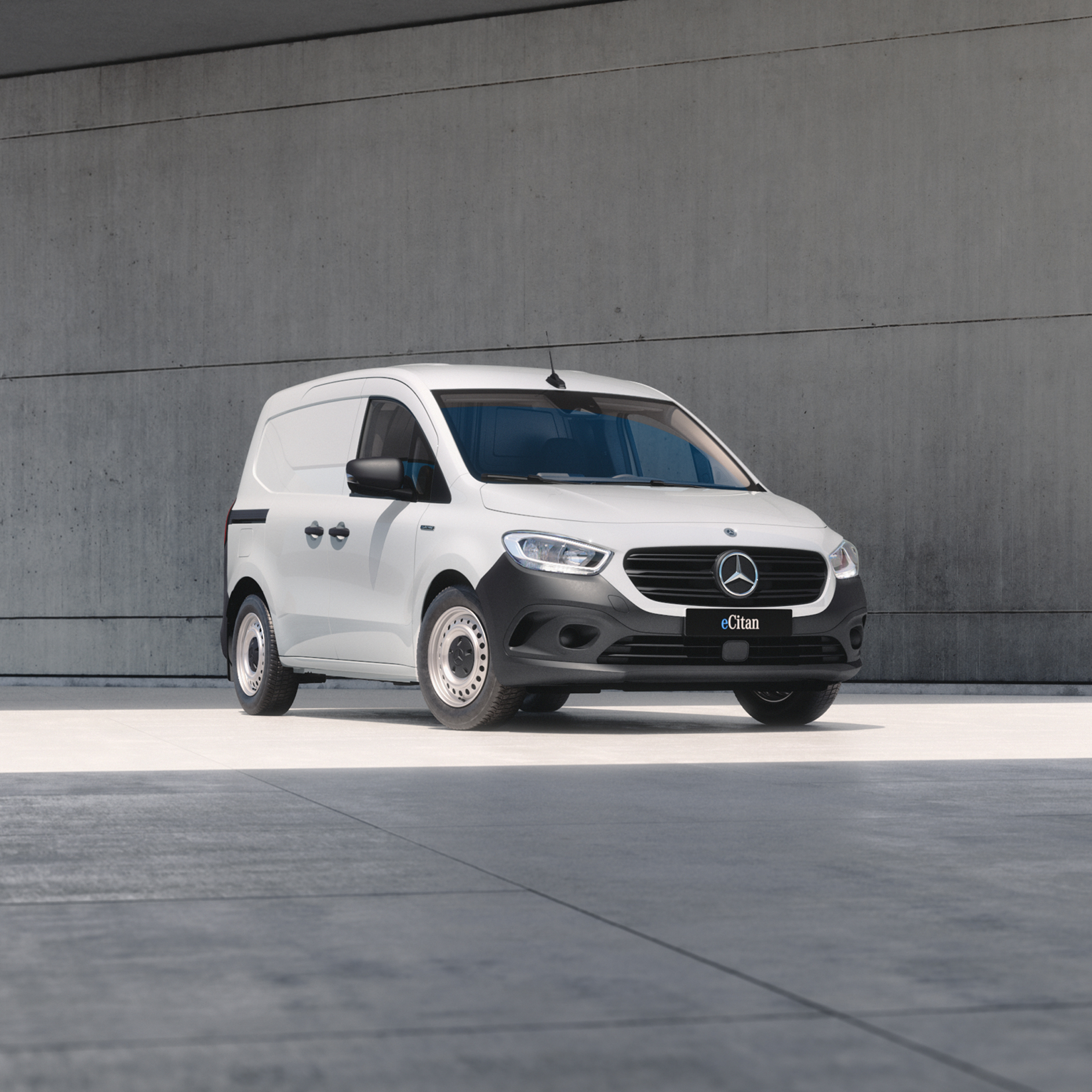 eCitan Panel Van | Mercedes-Benz Vans White Mercedes-Benz eCitan Panel Van parked by modern concrete structure.