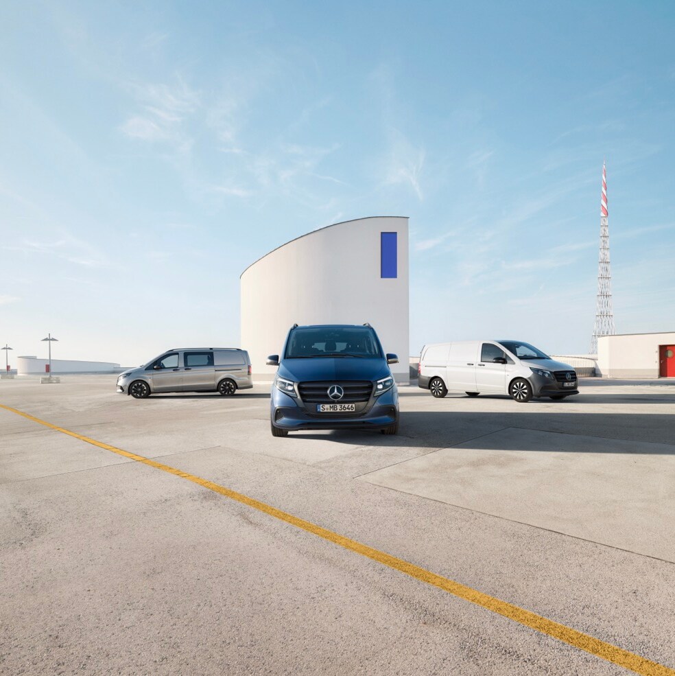 Close-up of the bonnet of a Mercedes-Benz eSprinter, showing the van plugged in and charging in a parking space.