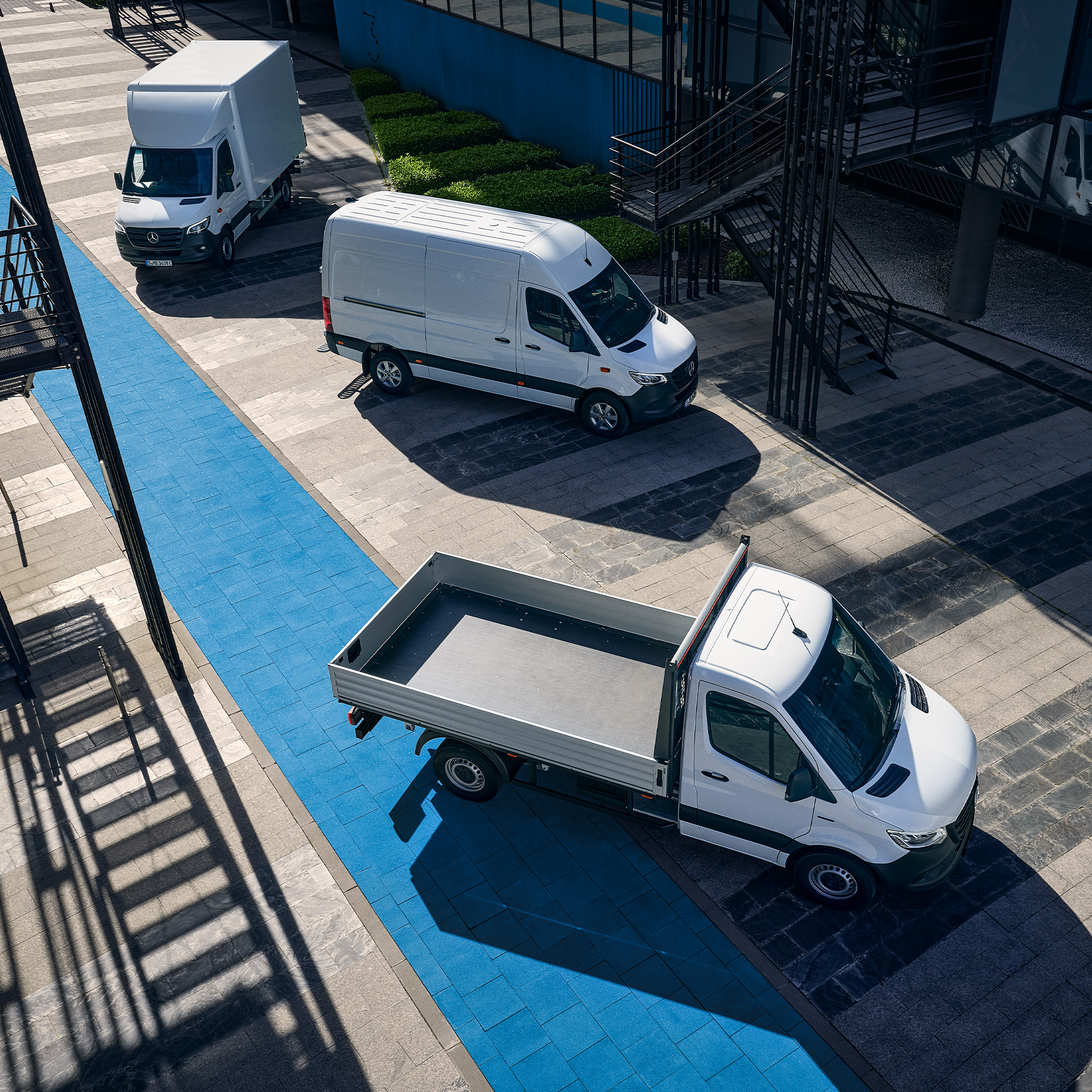 Sprinter Panel Van, Luton Box Van & Chassis Cab | Mercedes-Benz Vans A group of Mercedes-Benz Sprinter vans parked on a street, featuring a panel van, a Luton box van and a chassis cab.