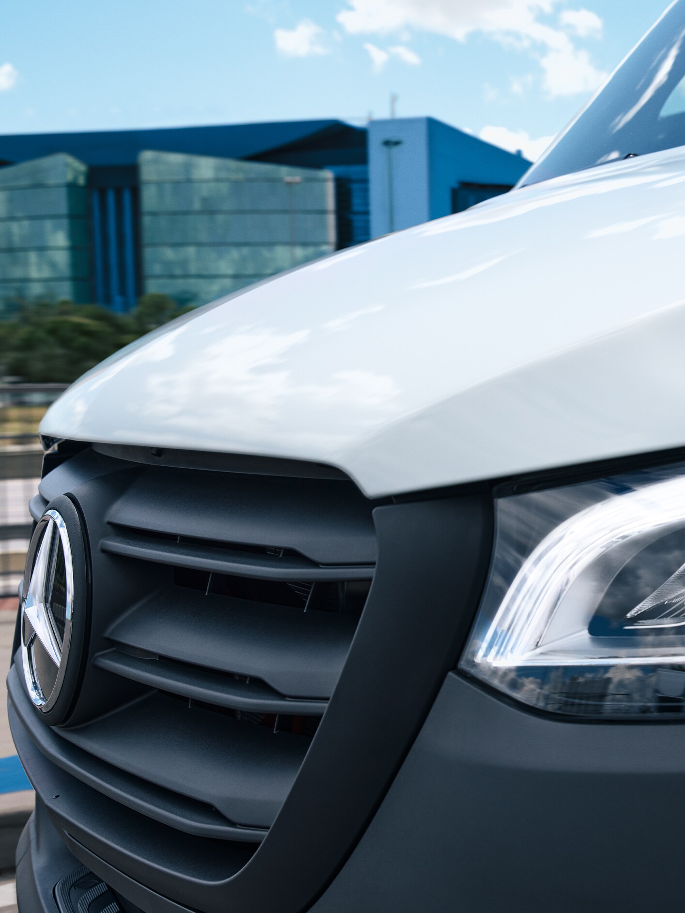 A close up of the front of a Mercedes-Benz Sprinter Luton van.