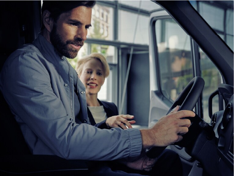 Man and woman talking with Mercedes-Benz dealer