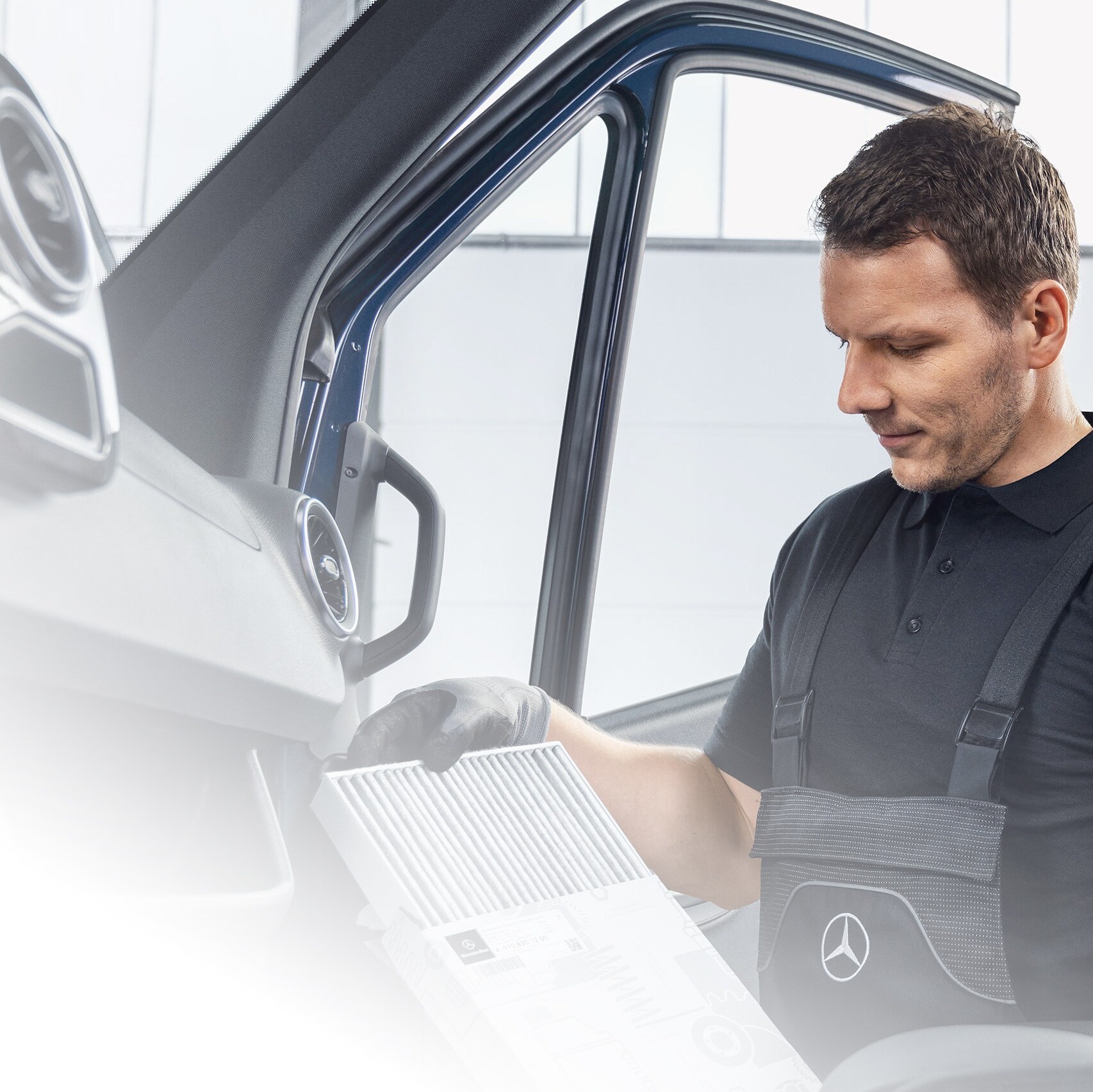 Mechanic checking Mercedes-Benz GenuineParts inside the van.